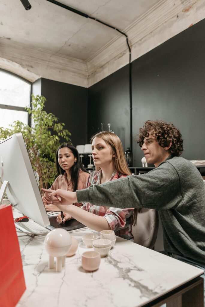 A diverse team discusses strategies in a modern office setting, using technology to enhance creativity.